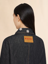 Black denim jacket with daisy appliqués